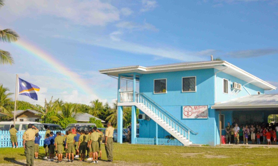 students raising marshall islands flag