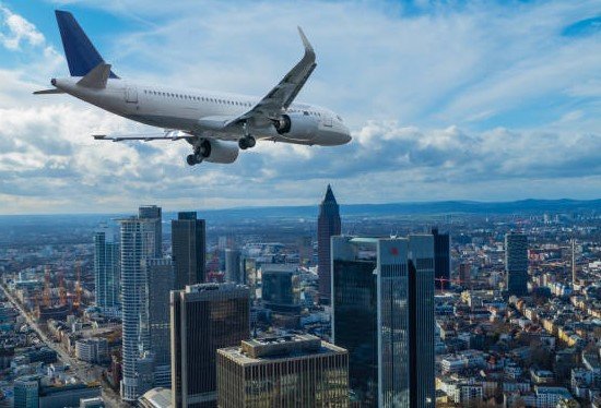 airplane over city skyline
