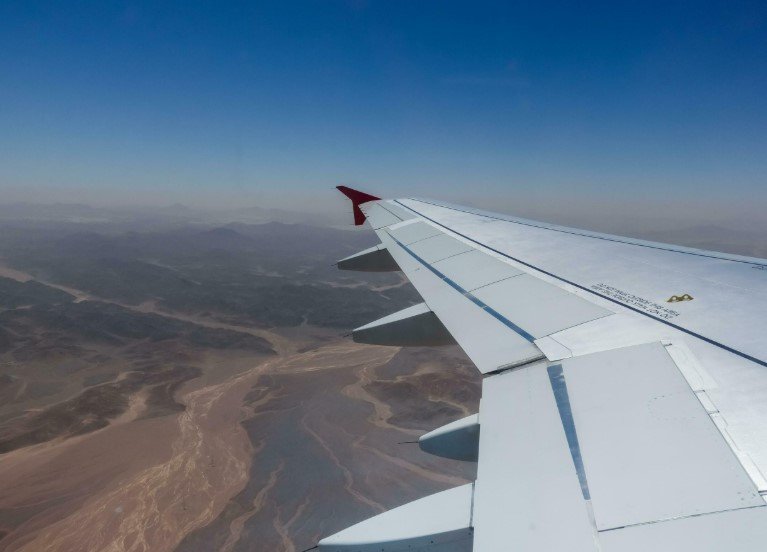airplane over desert city