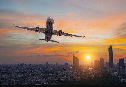 airplane over city skyline